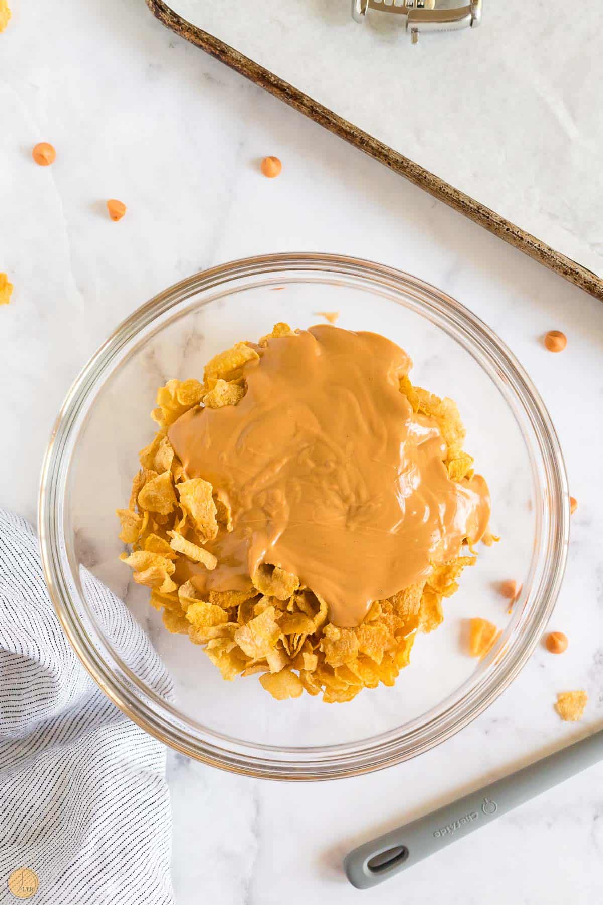 peanut butter poured over cereal in a clear bowl