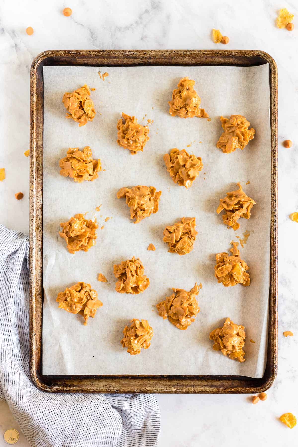 cookie dough mounds on a baking sheet with parchment paper