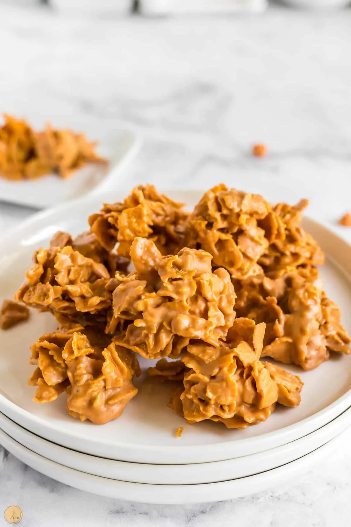 stack of butterscotch no bake cookies on white plates