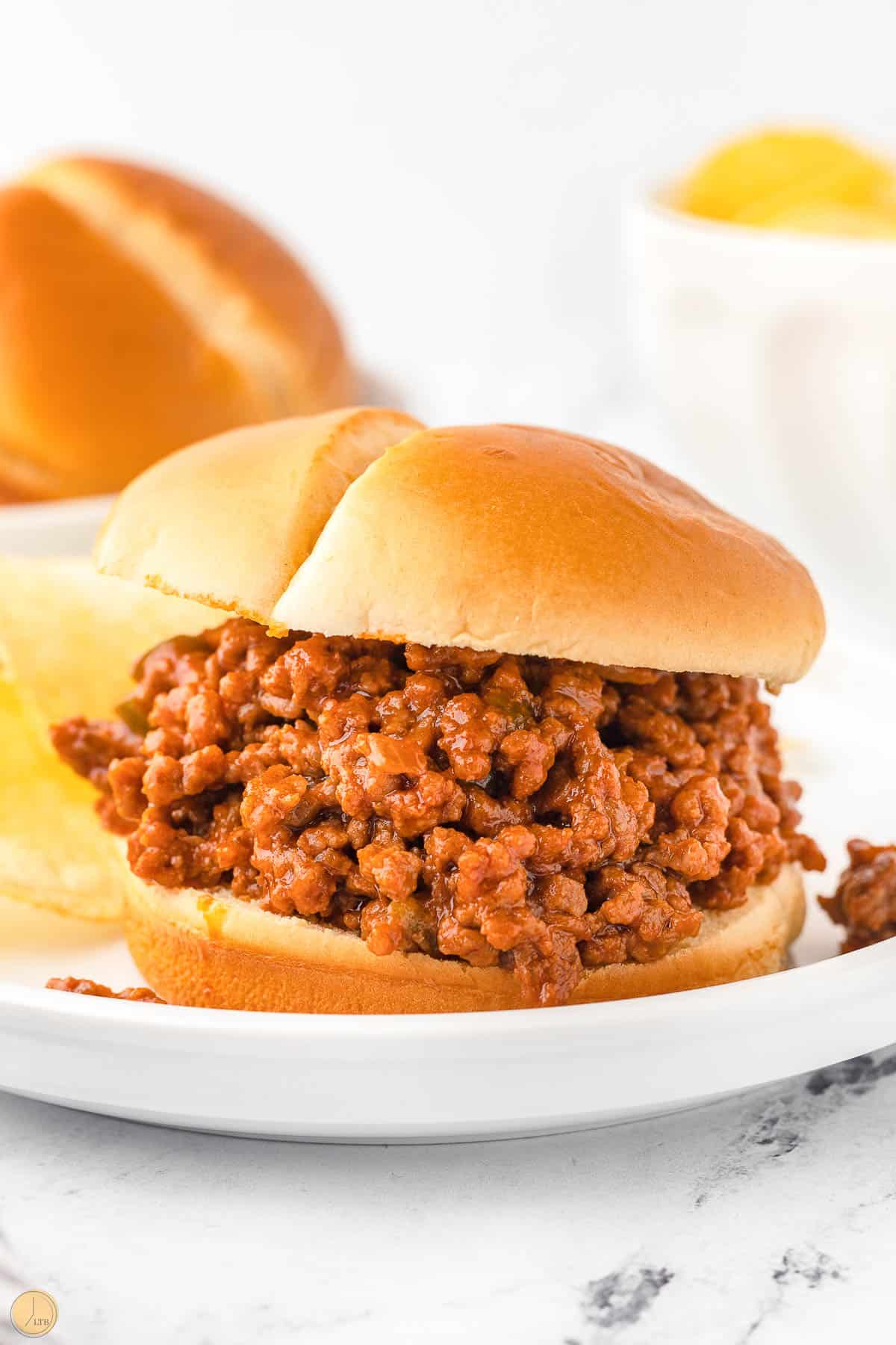 white plate with homemade sloppy joes recipe on toasted bun