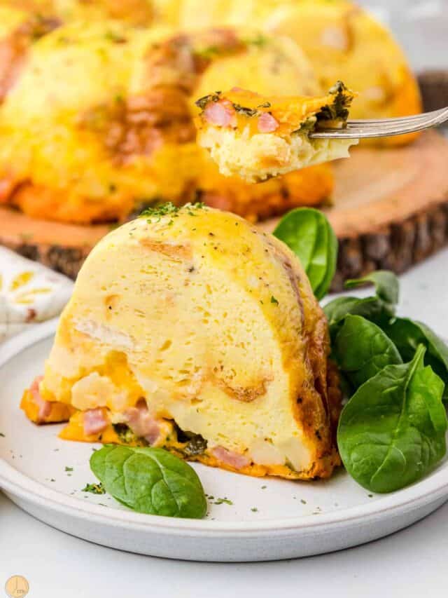 slice of egg bundt cake with fresh spinach on the plate