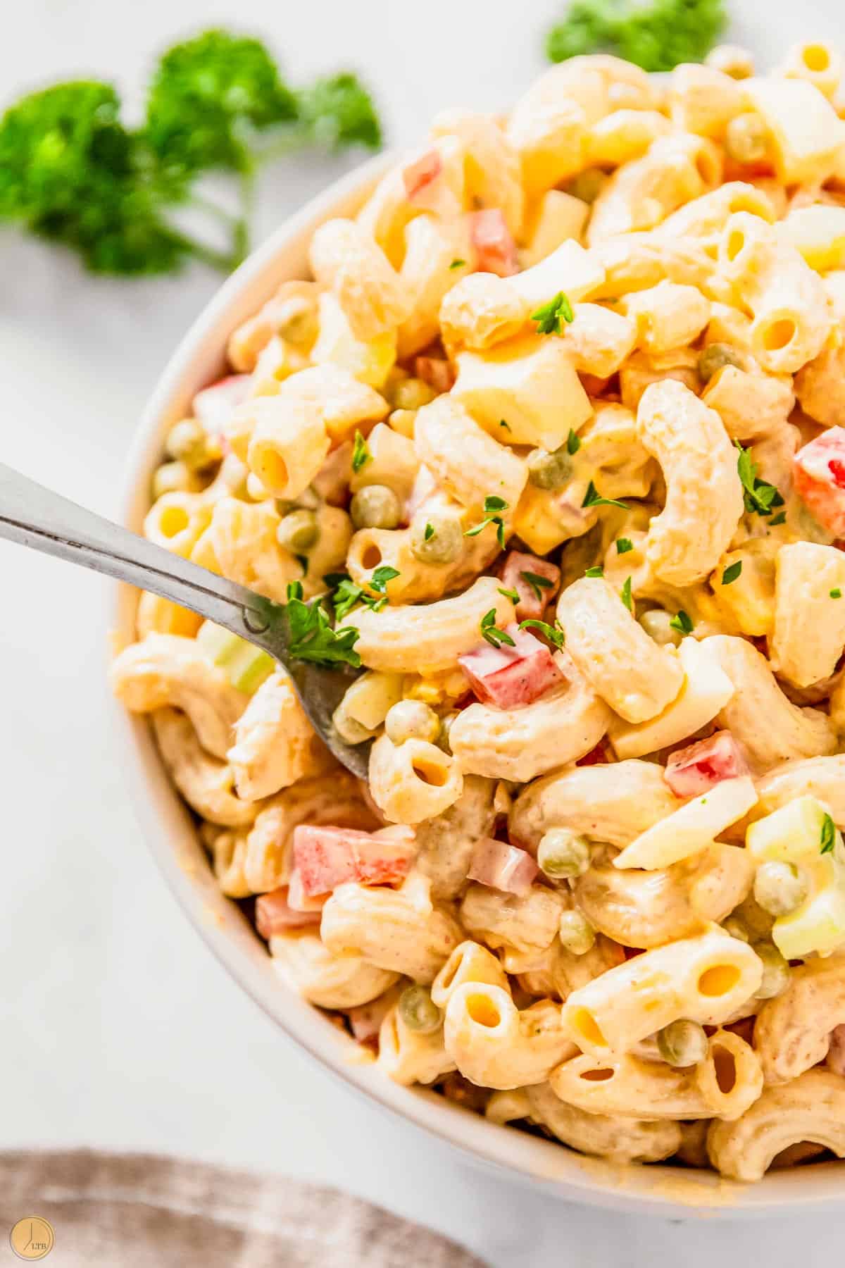 spoon of pasta salad with parsley on it