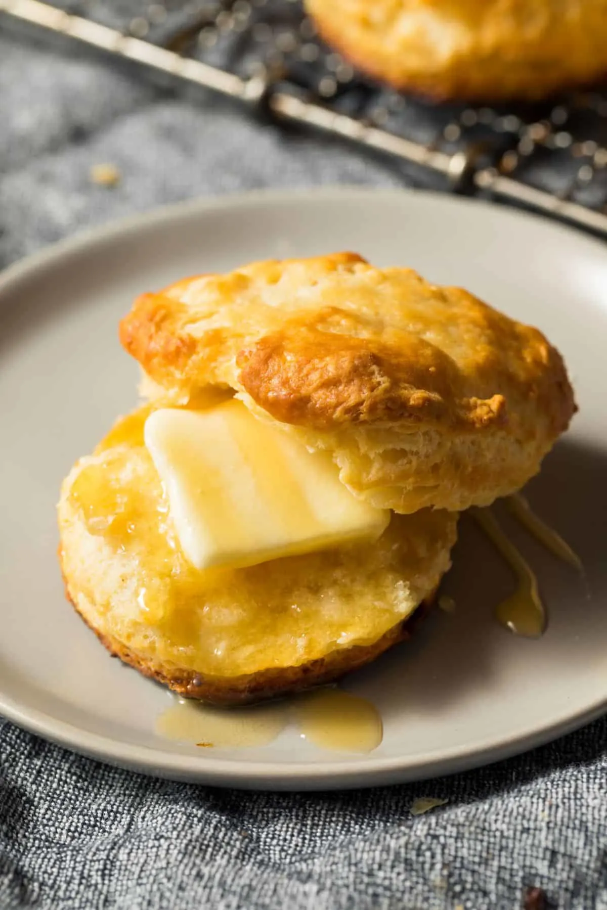 delicious biscuits on a plate with butter and honey