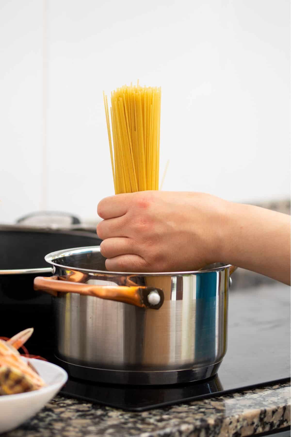 hand holding spaghetti