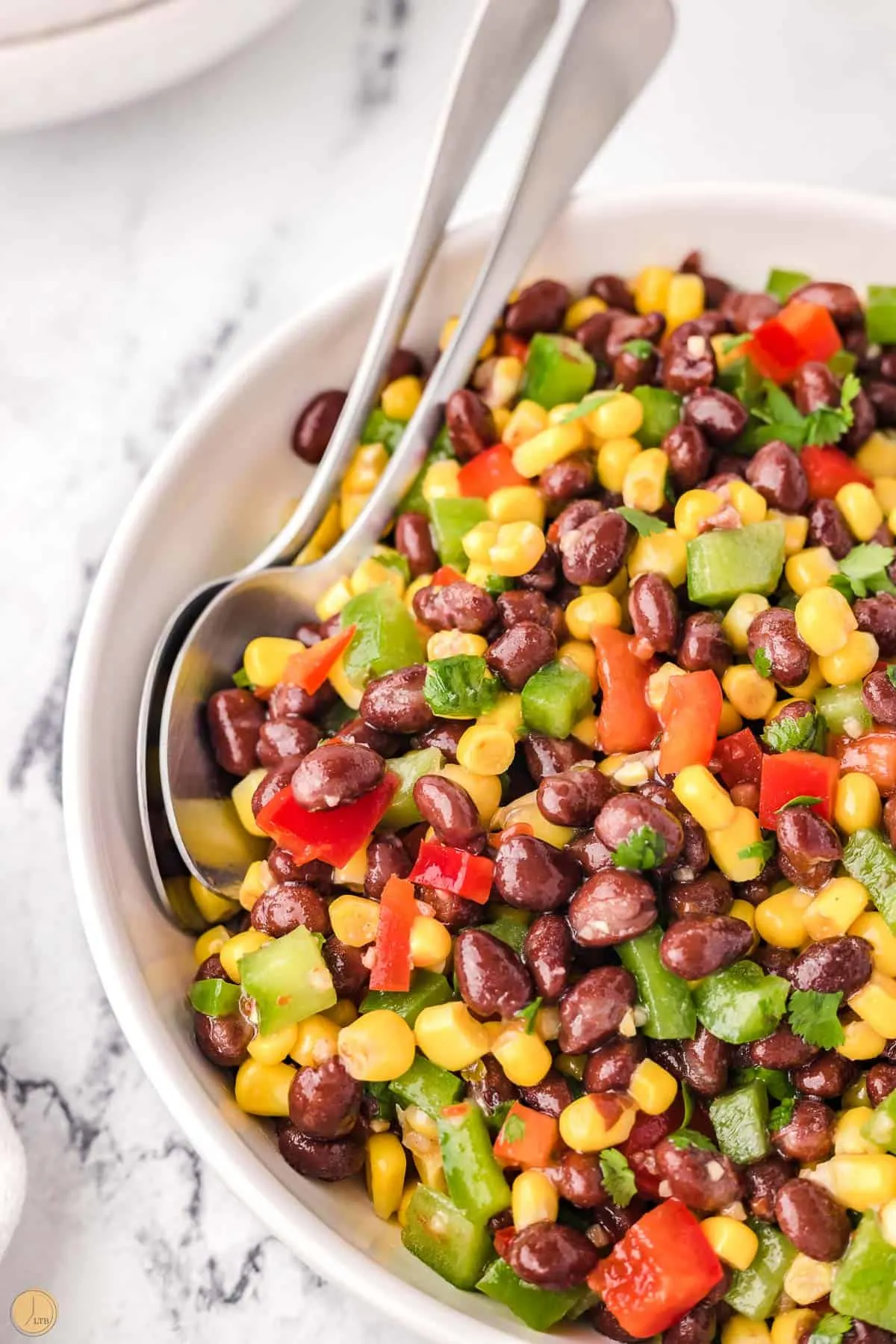 fresh foods in a bowl with two spoons