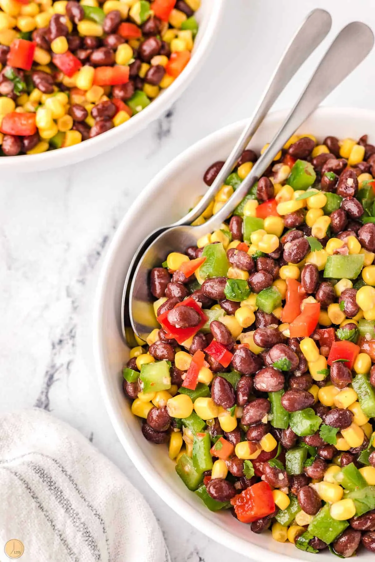 corn and black bean salsa in a bowl with spoons