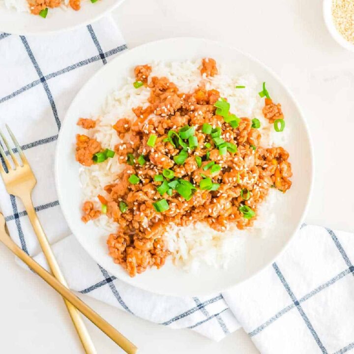 plate of ground orange chicken with forks
