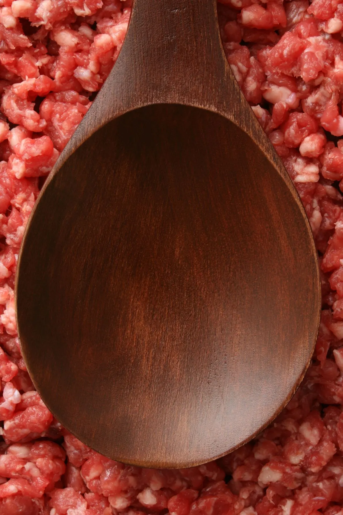 wood spoon on top of ground beef