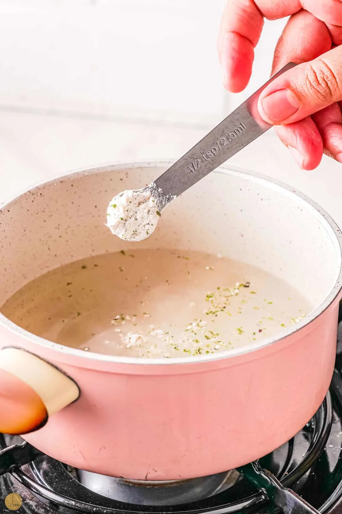 spoon of dry gravy mix over a pot