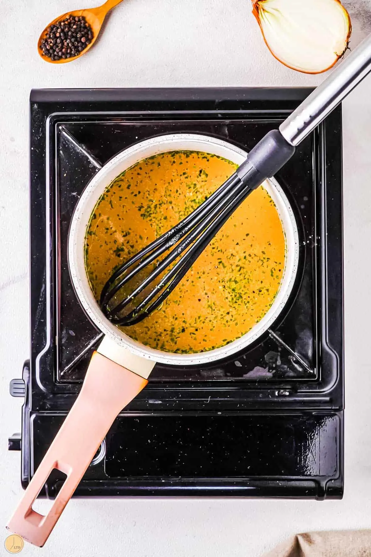 gravy in a pot with a whisk