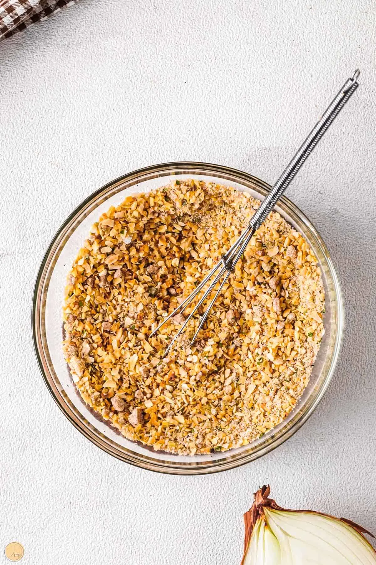 dry spice mix in a bowl with a whisk