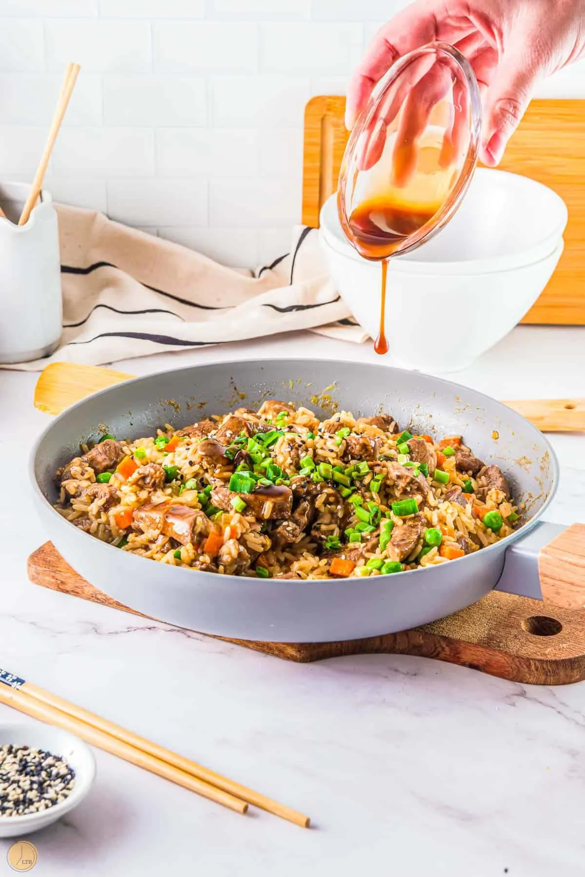 dark soy sauce drizzling over rice