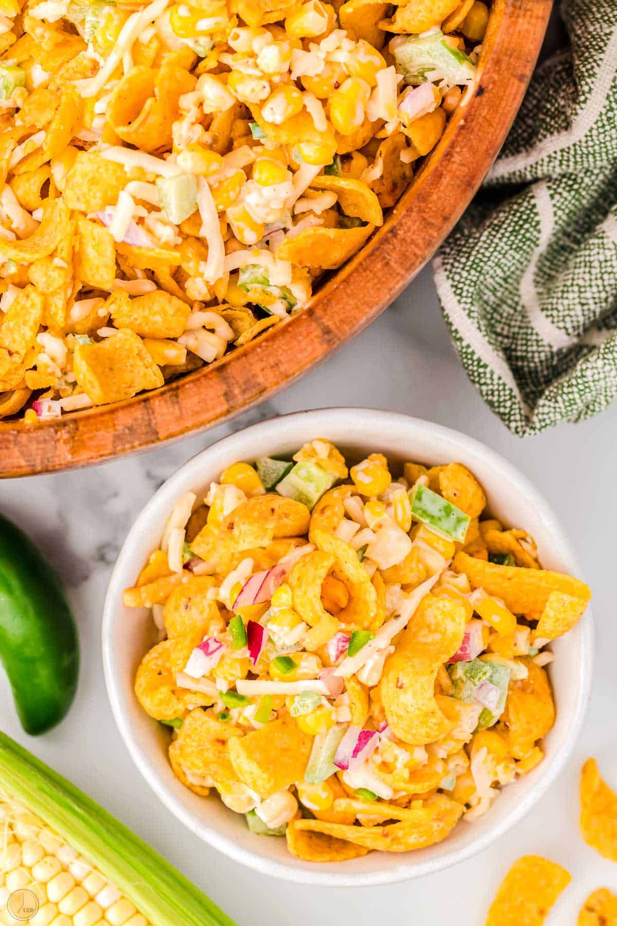 two bowls of corn salad with fritos in it