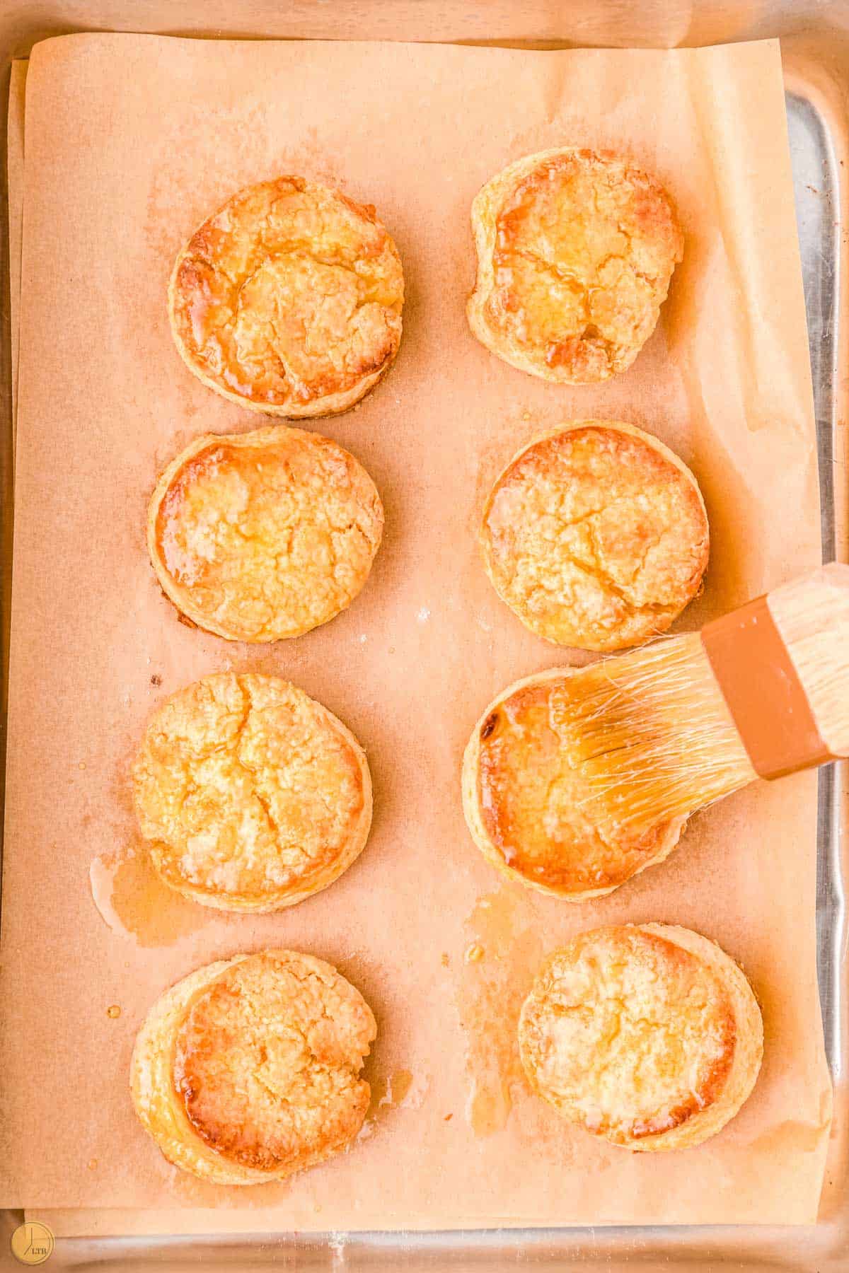 biscuits being brushed with melted butter