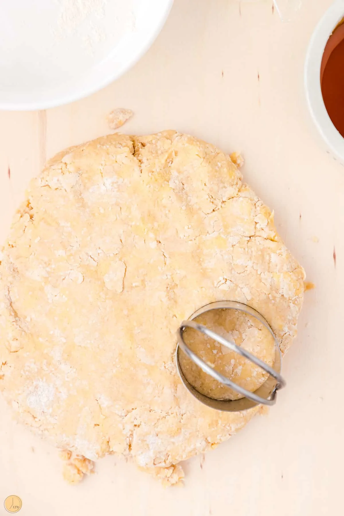 biscuit cutter cutting dough into circles