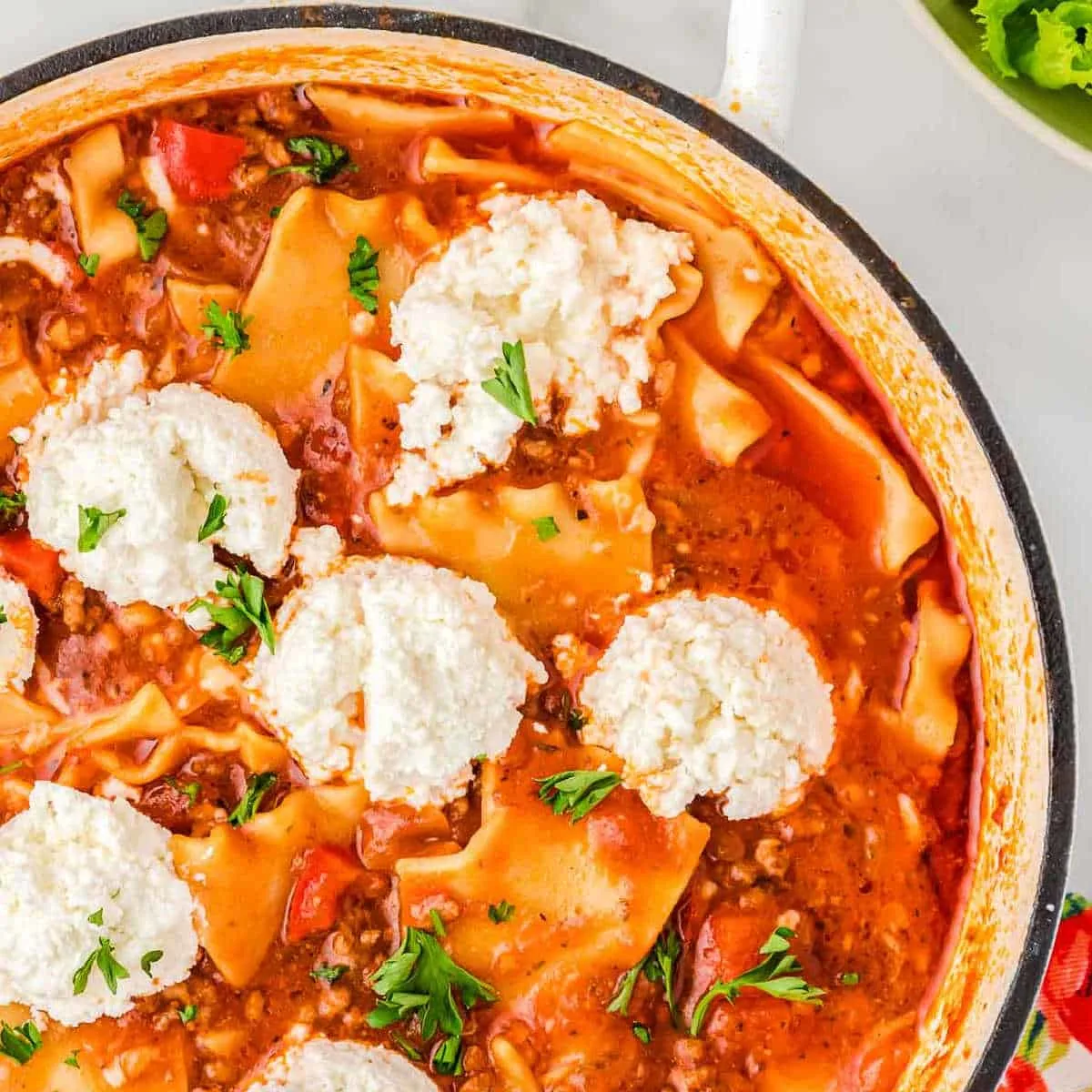 white pot filled with spicy lasagna soup