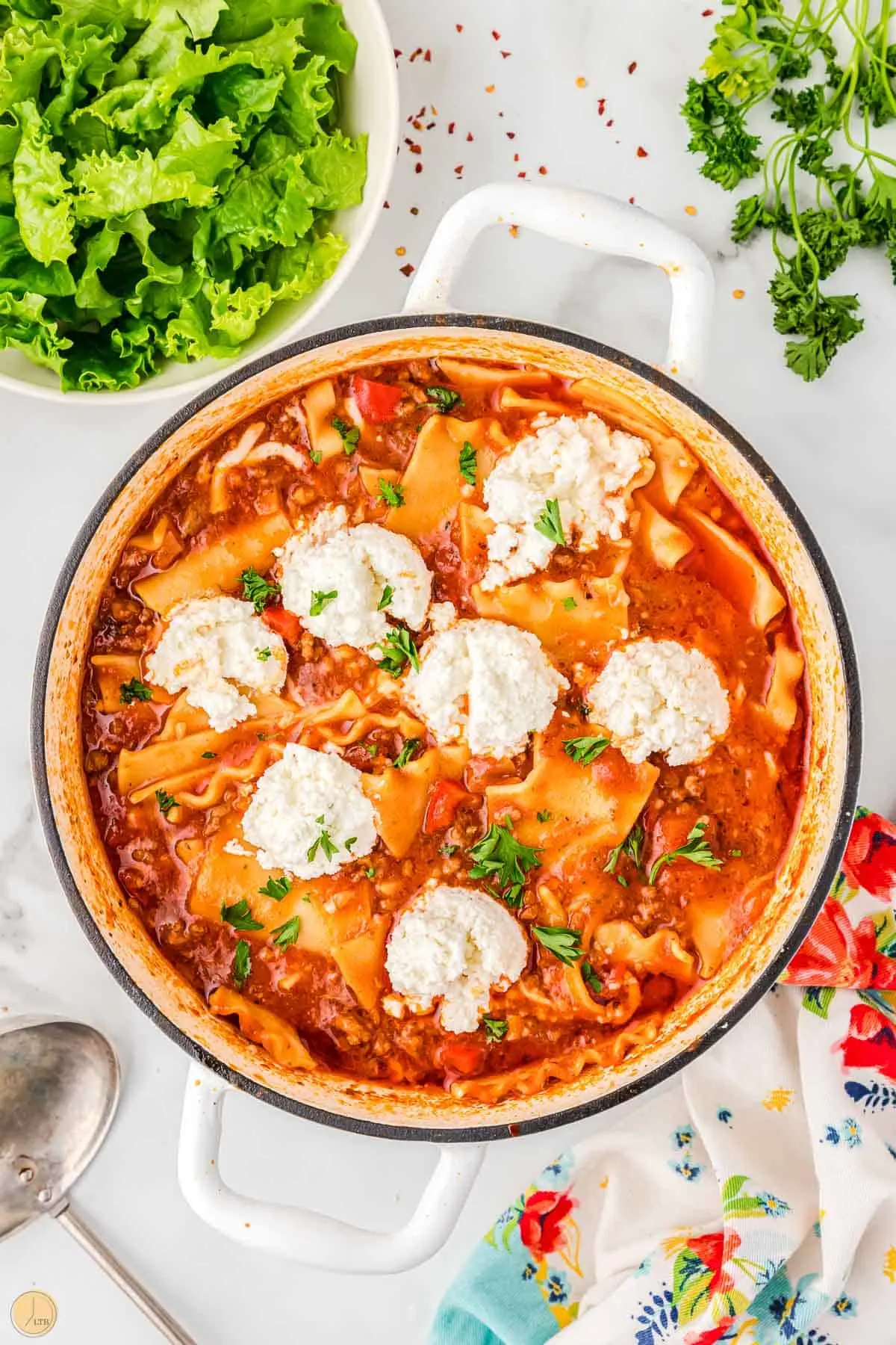 pot of lasagna soup with dollops of ricotta cheese on top