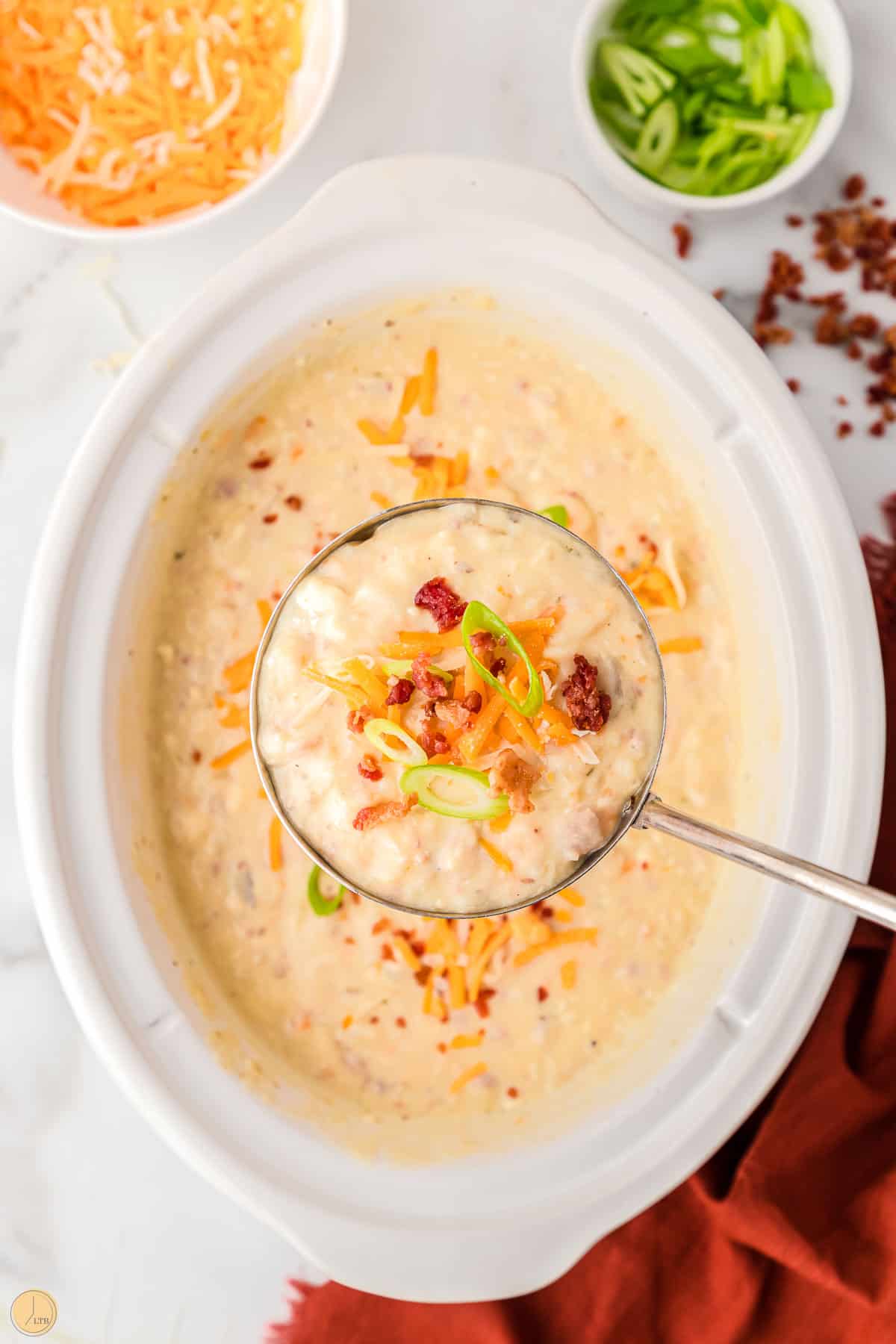 crack potato soup in a ladle