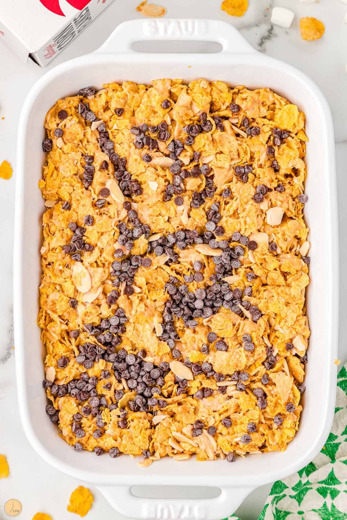 chocolate chips and cornflake bars in a white pan