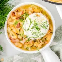bowl of dilly bean stew with sour cream on top