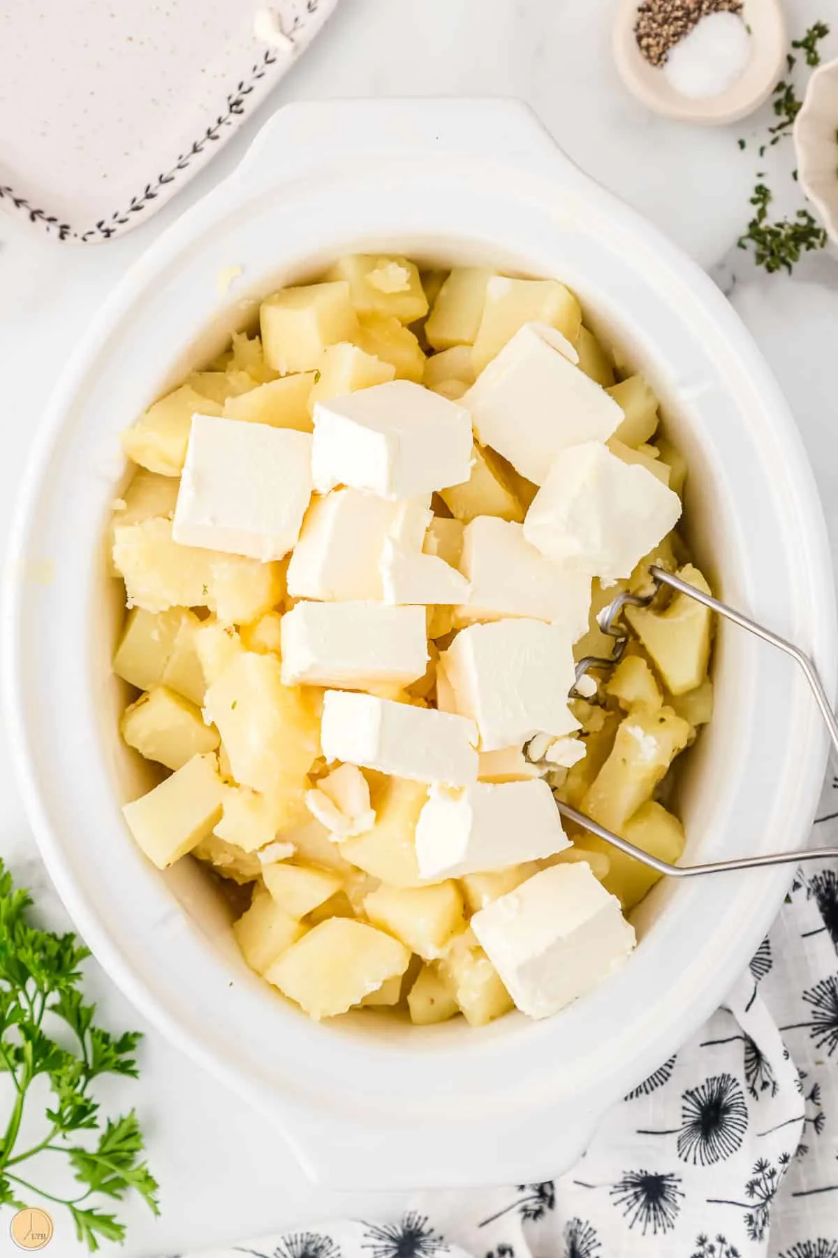 cream cheese cubes on diced potatoes