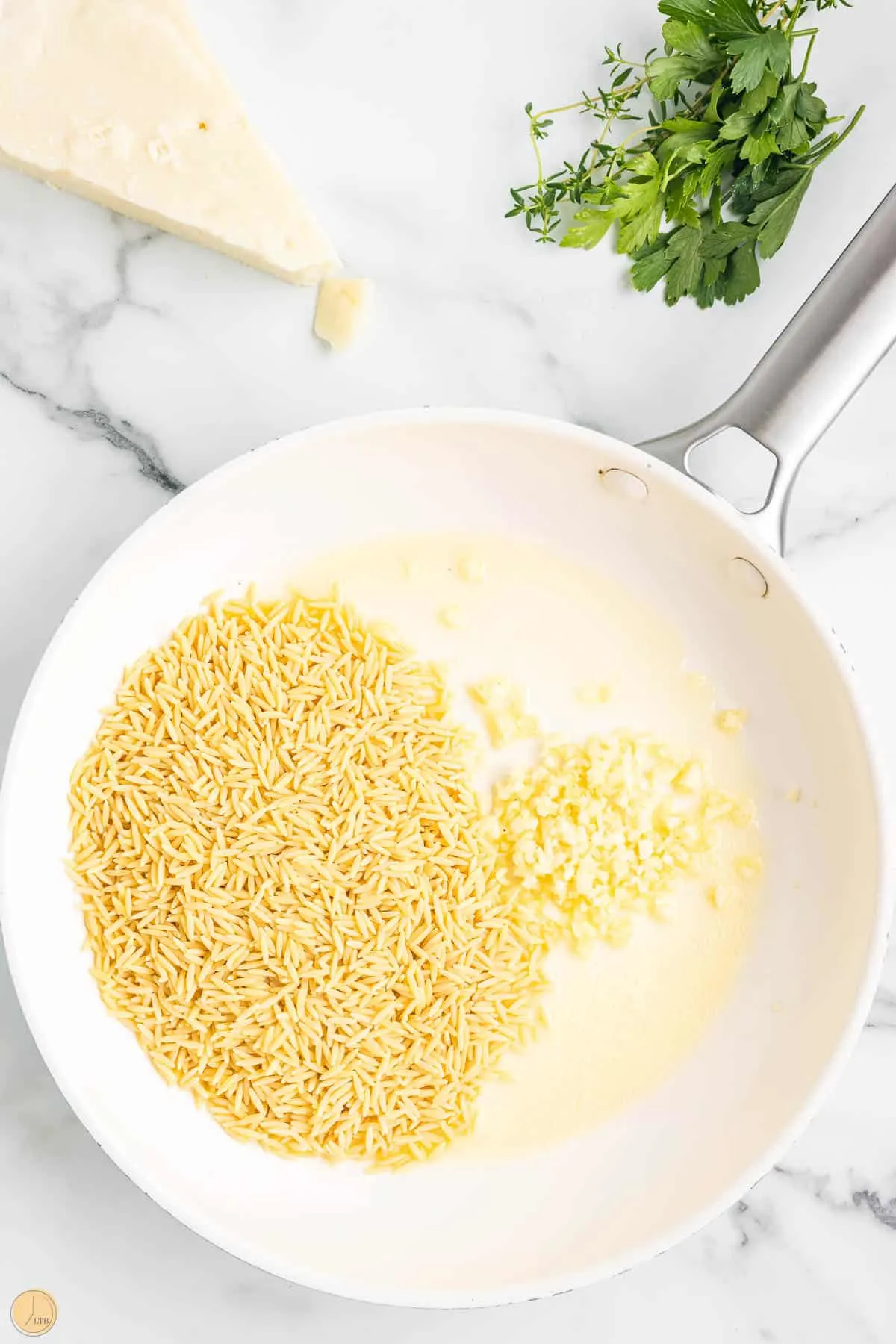 orzo and garlic in a pan