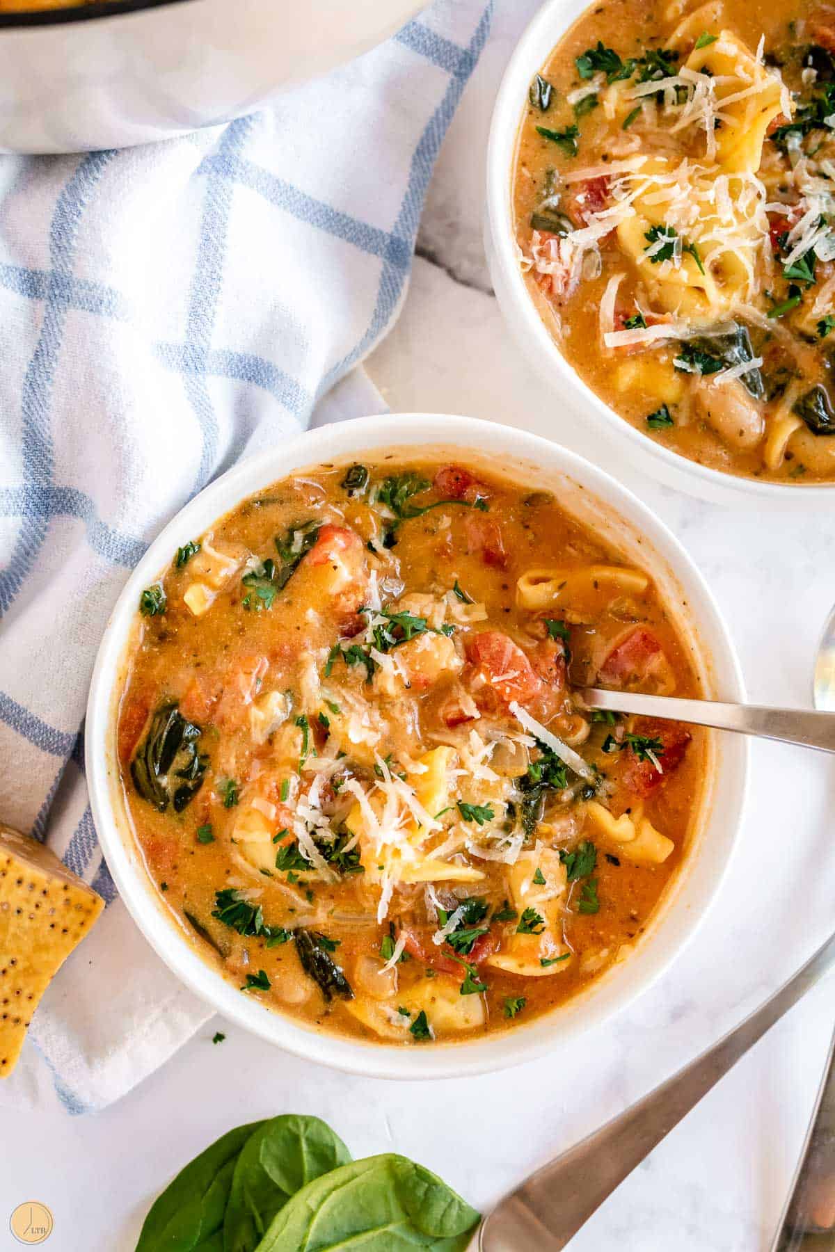 hearty soup in two bowls with spoons