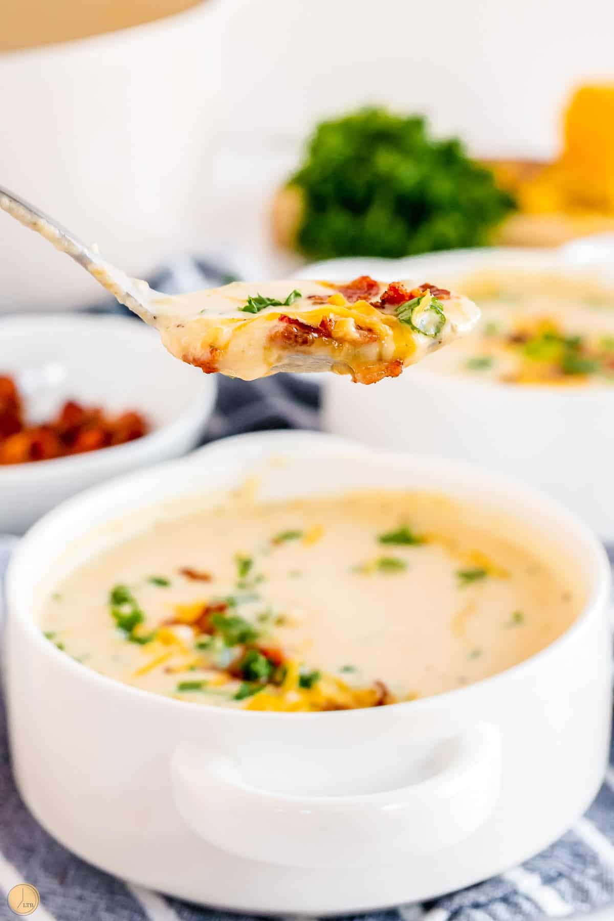 creamy roasted cauliflower soup in a spoon