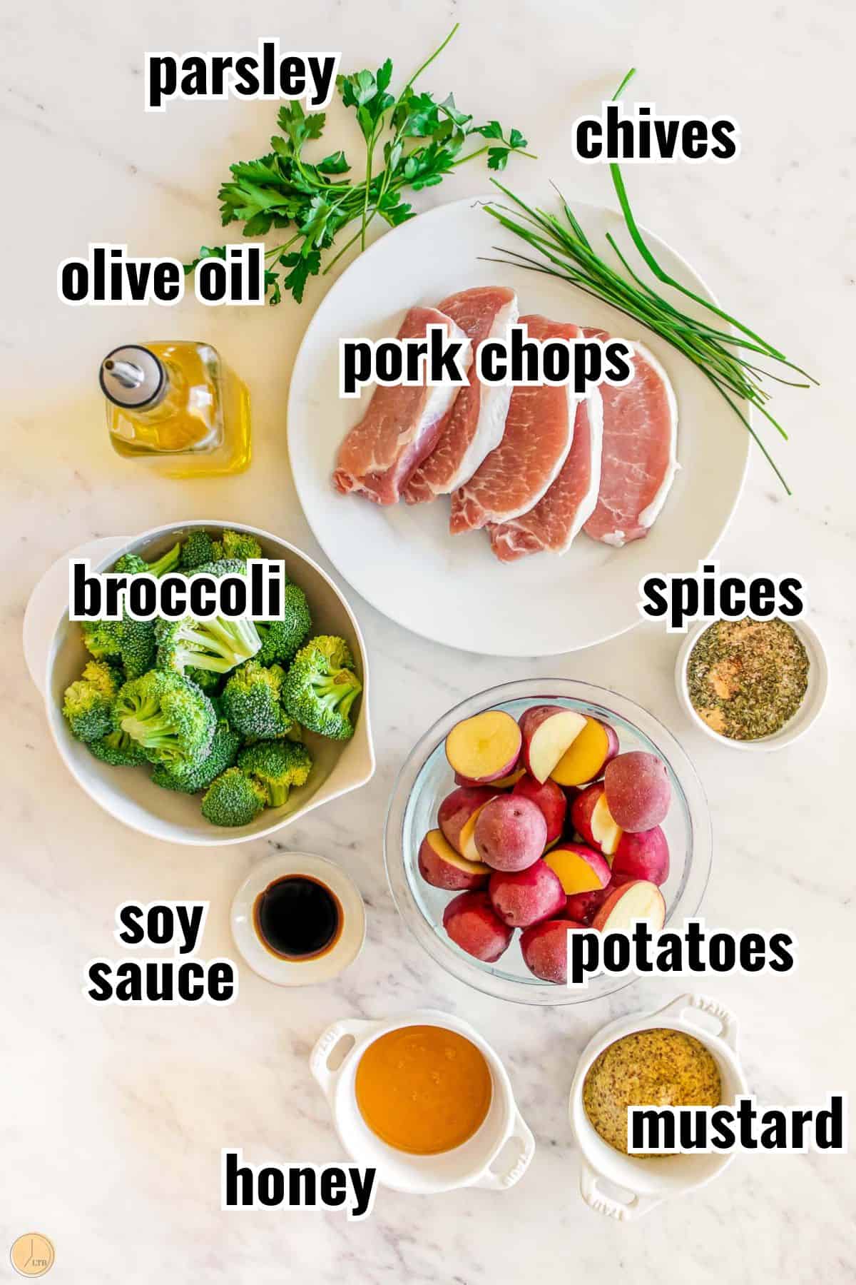 ingredients for a meal that include tender pork chops, whole grain mustard, and herbs.
