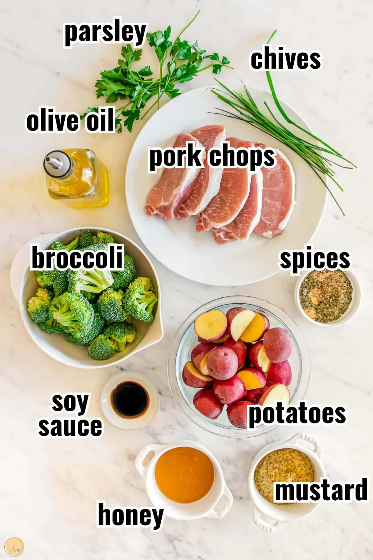 ingredients for a meal that include tender pork chops, whole grain mustard, and herbs.