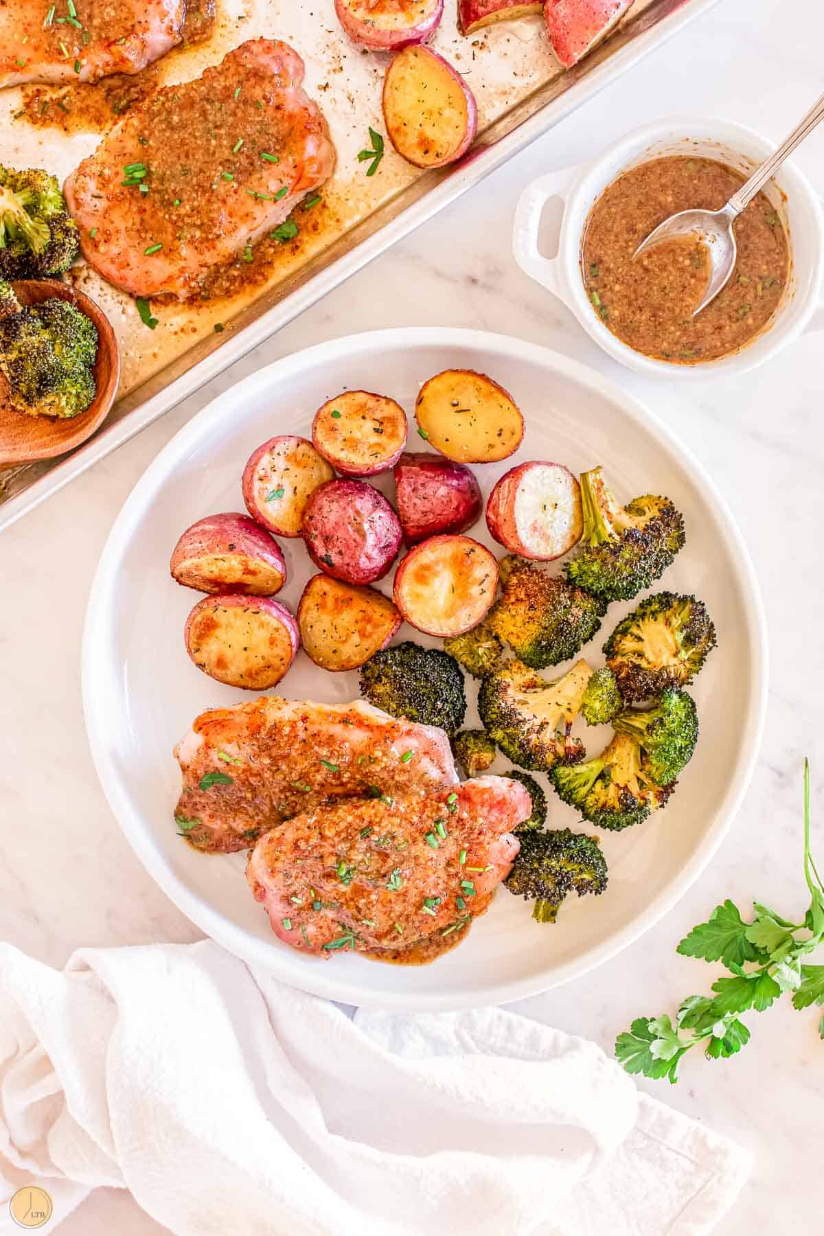 honey mustard pork chops and broccoli with potatoes make a great sheet pan meal