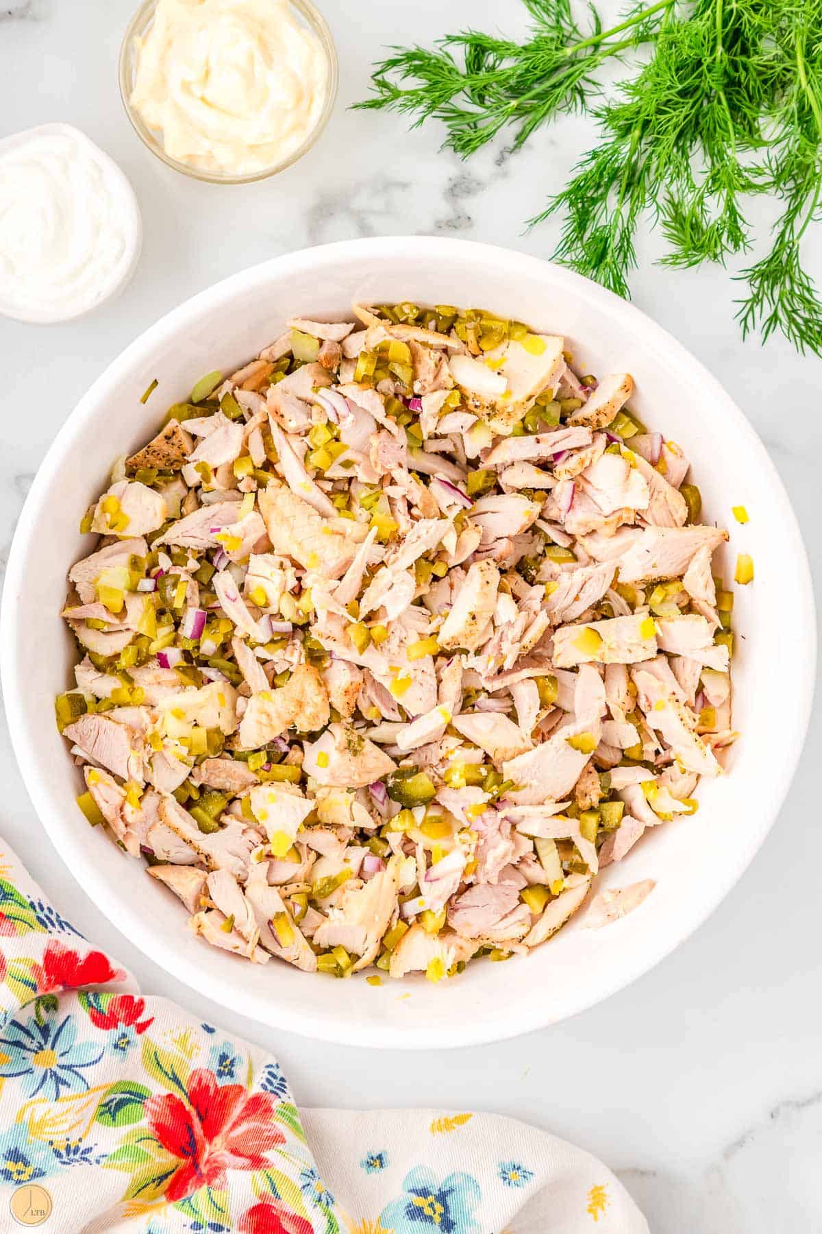 dill pickle chicken salad in a large bowl without dressing on it
