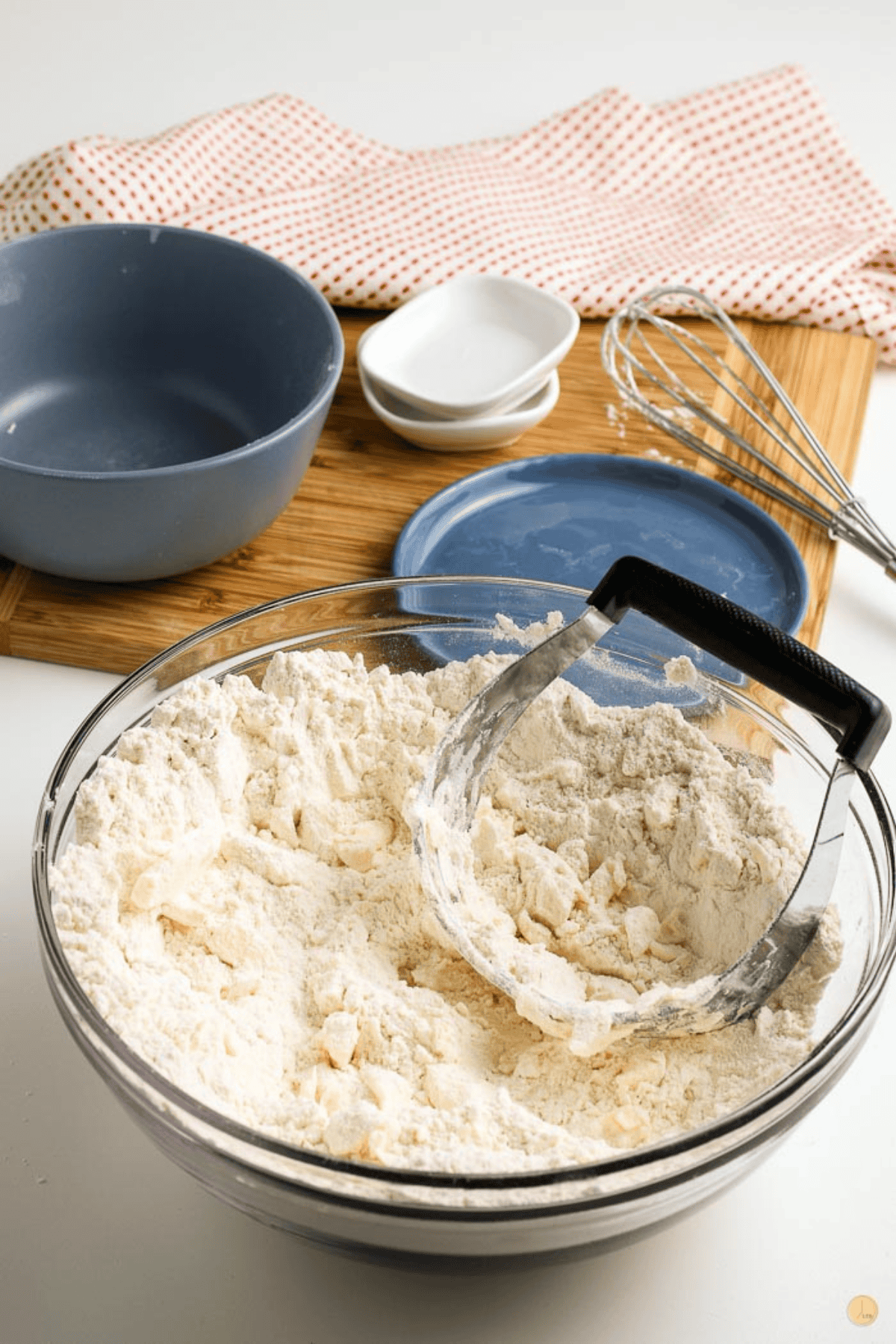 bowl of flour and butter with a pastry cutter