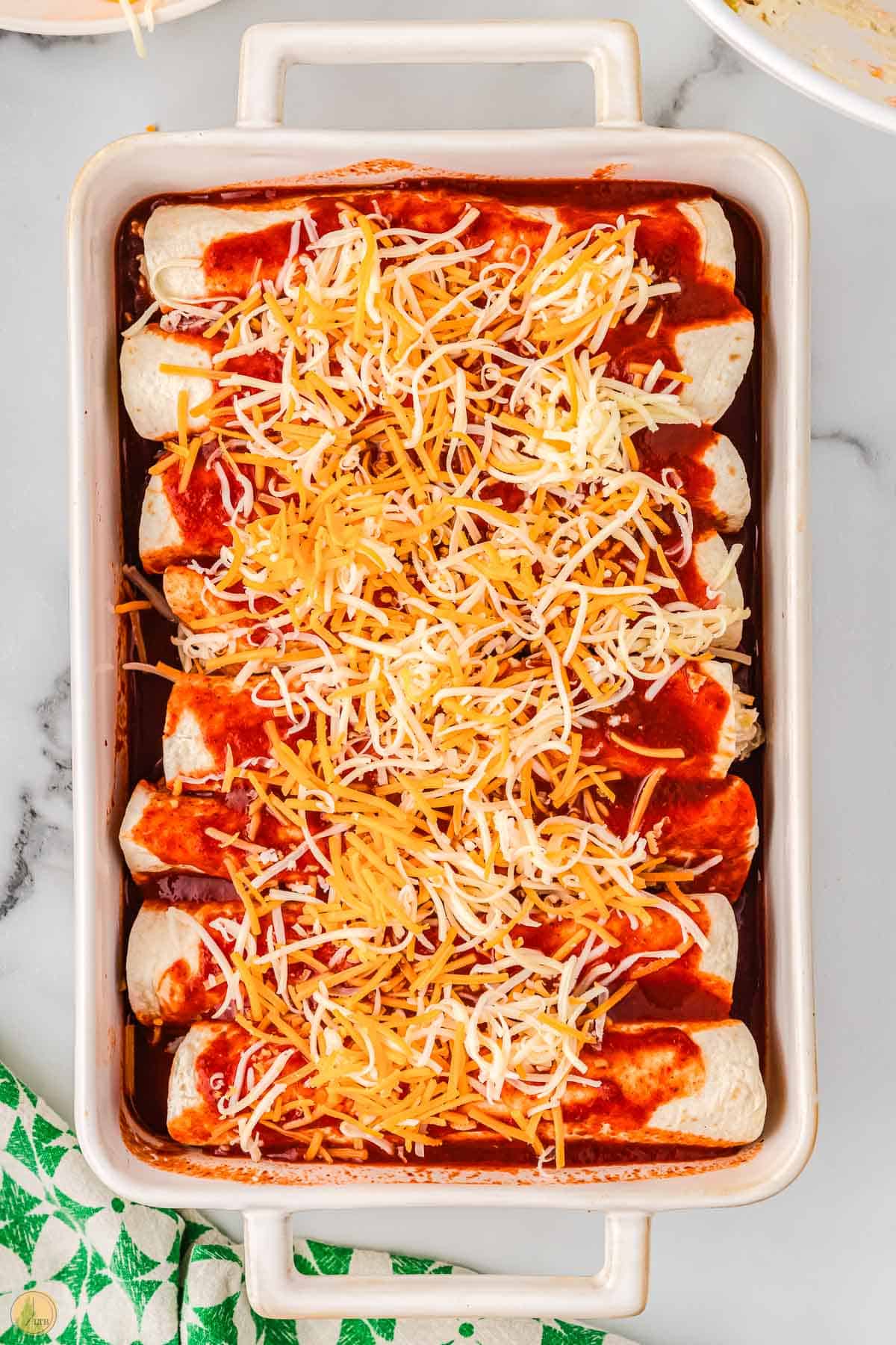 top them with the remaining shredded cheese before baking