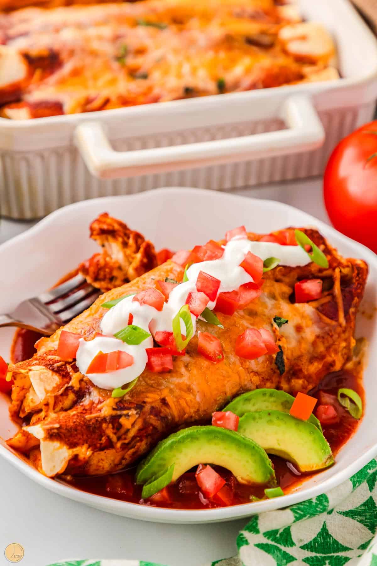 white chicken enchiladas with a red sauce on a plate