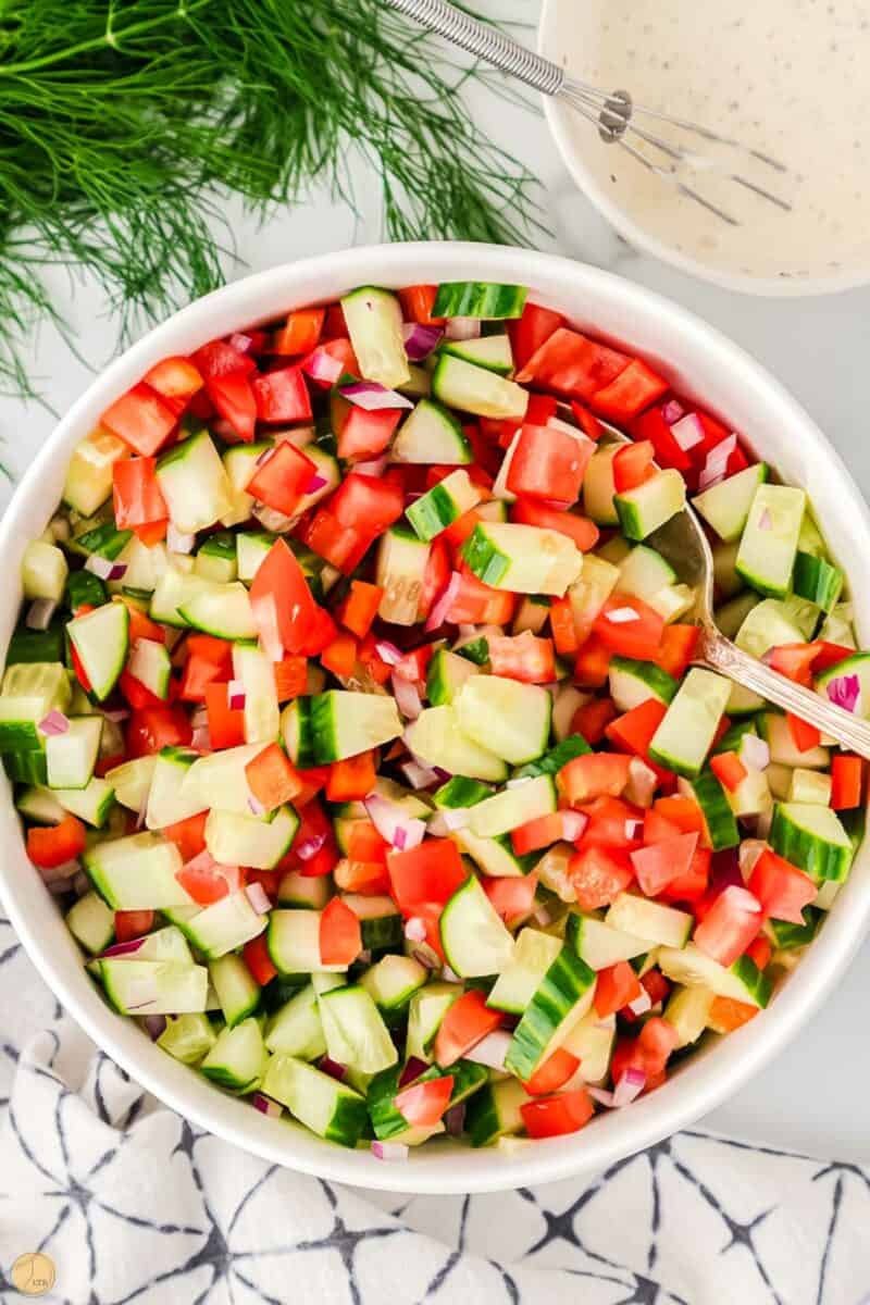 chopped cucumbers and tomatoes in a bowl