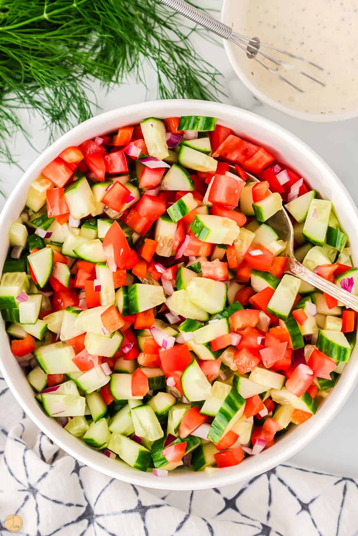 diced tomatoes and sliced cucumbers in a bowl