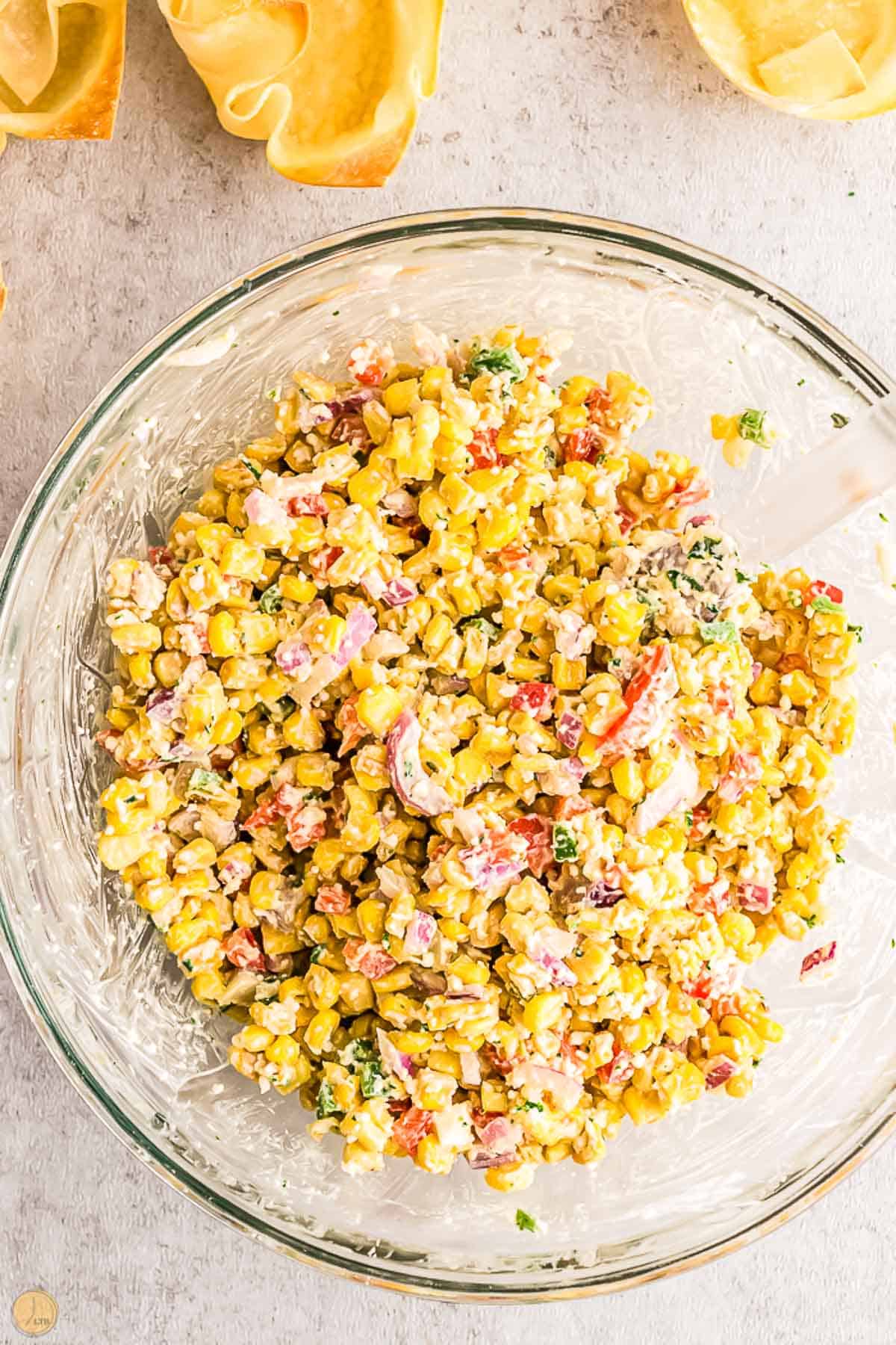 corn salad in a bowl with a spatula