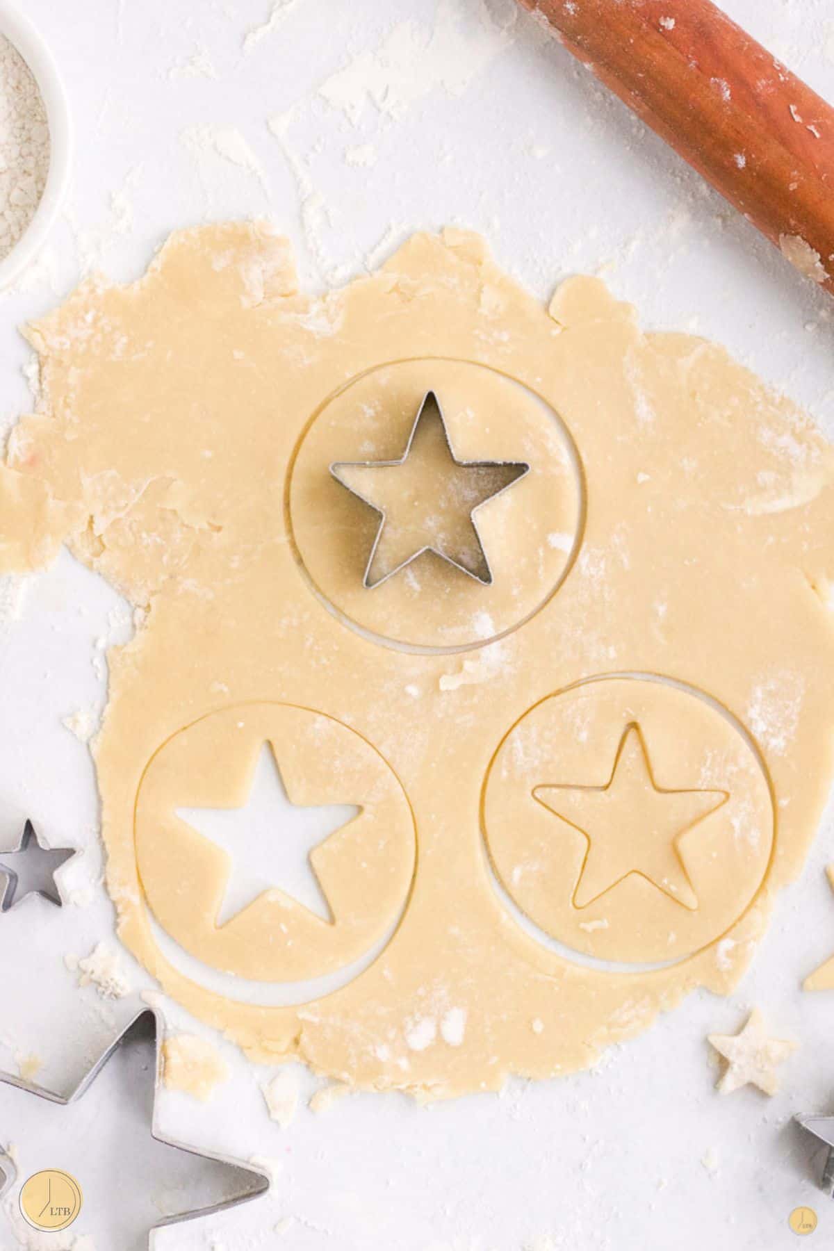 cookie cutter cutting out stars from dough