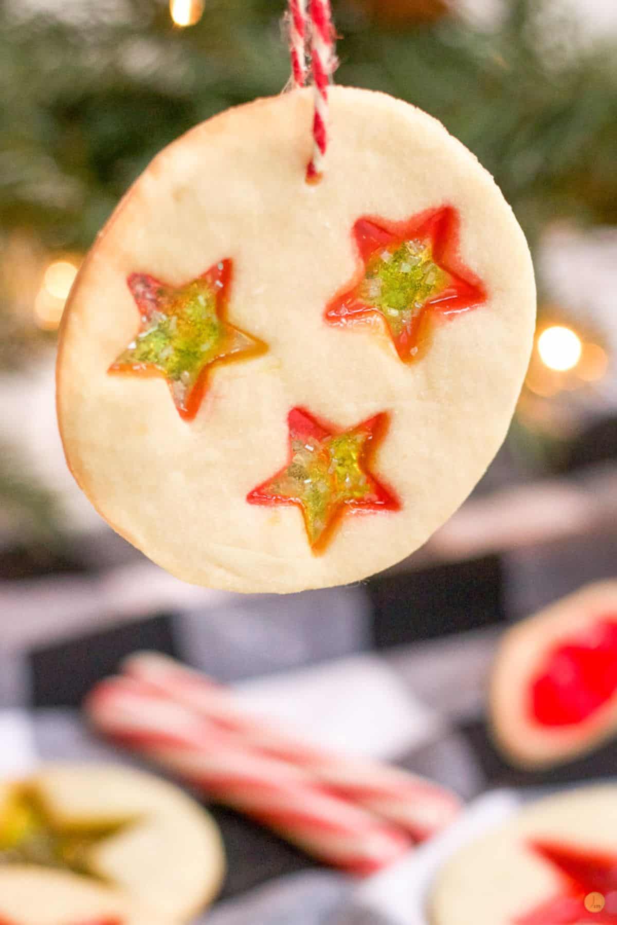 cookie ornament hanging from a red and white string