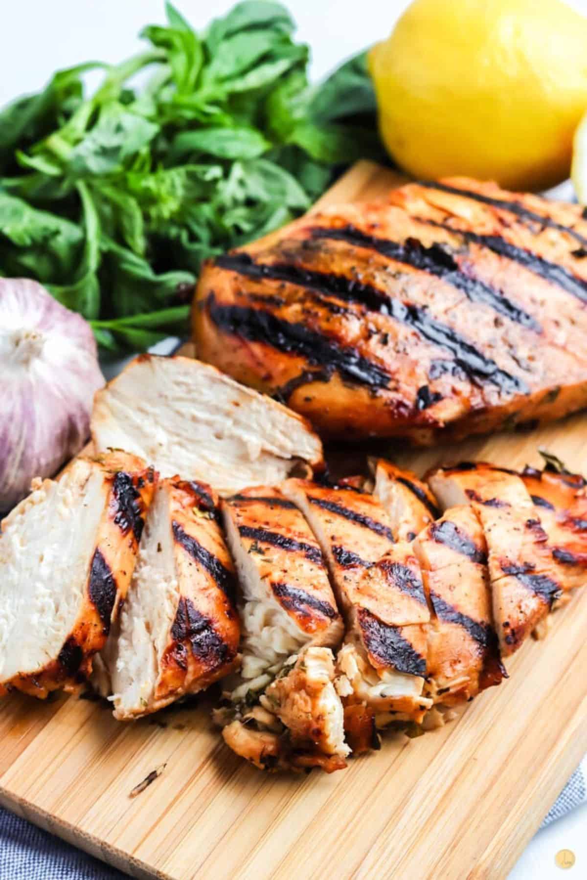 sliced chicken boneless chicken breasts on a cutting board