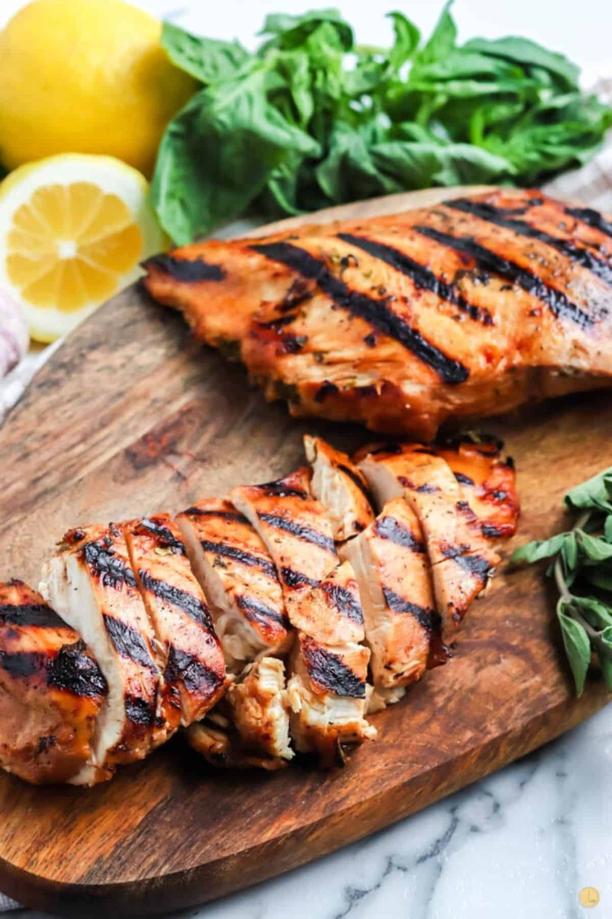 juicy chicken, sliced, on a wood board