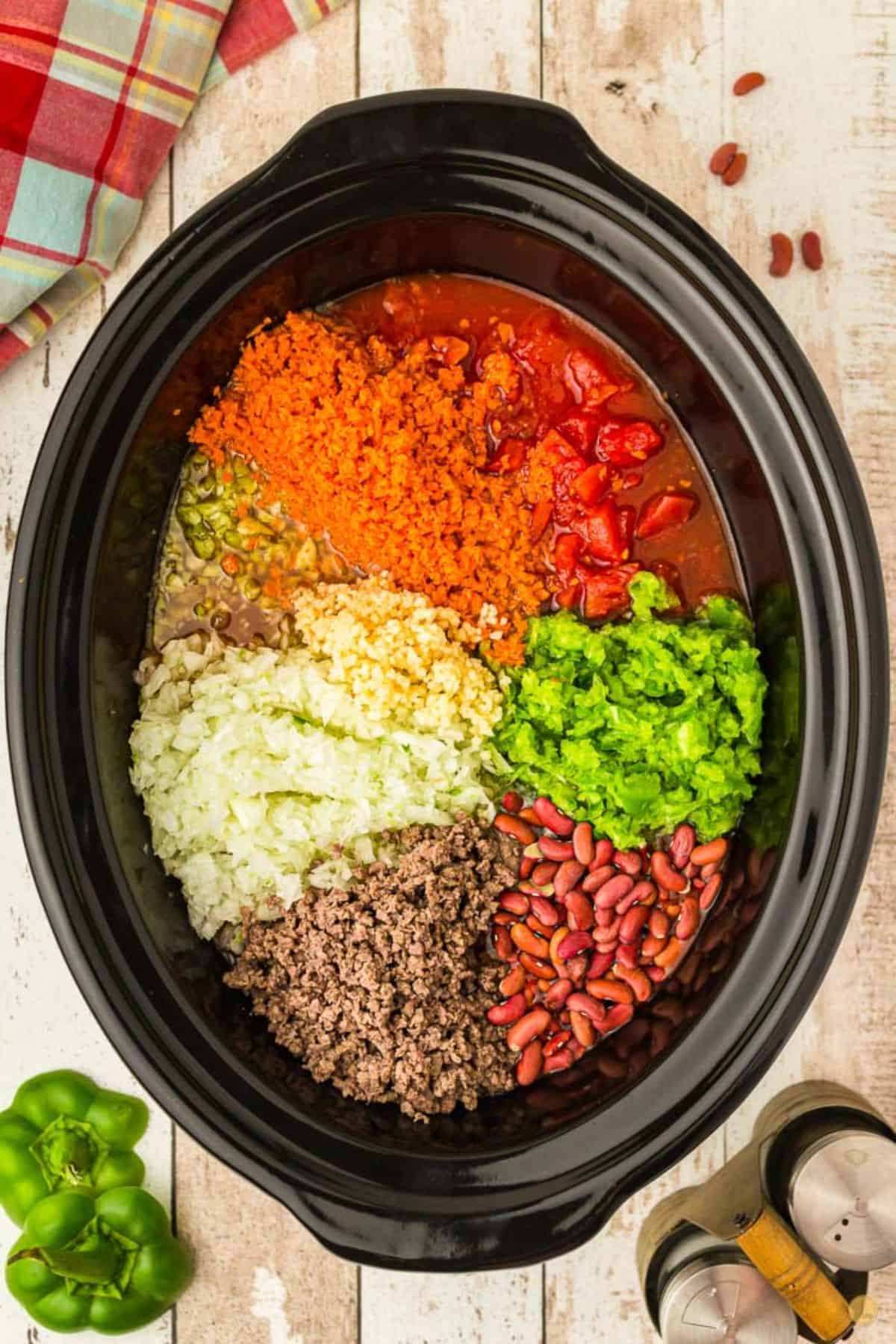 unmixed ingredients for chili in a crockpot 