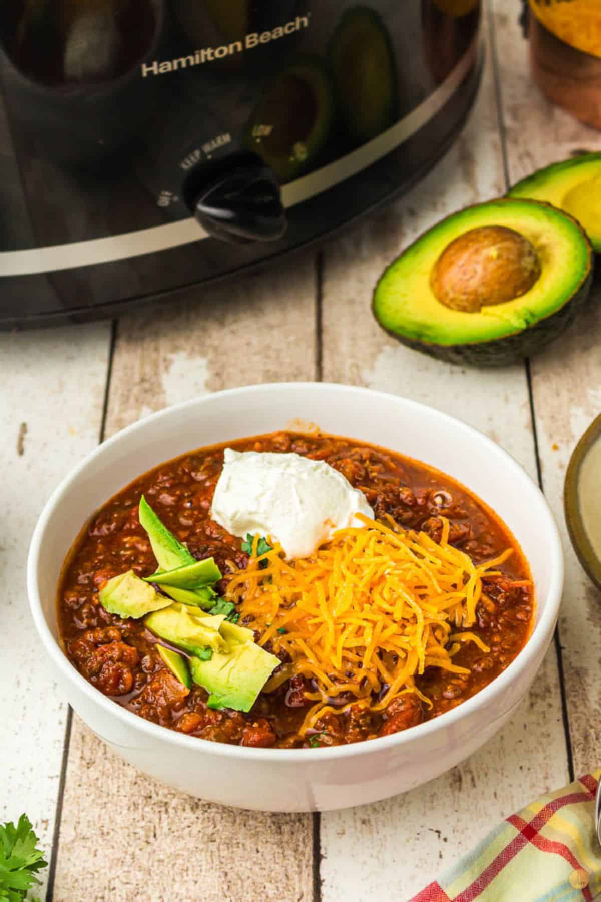 crock pot chili in a bowl with avocado