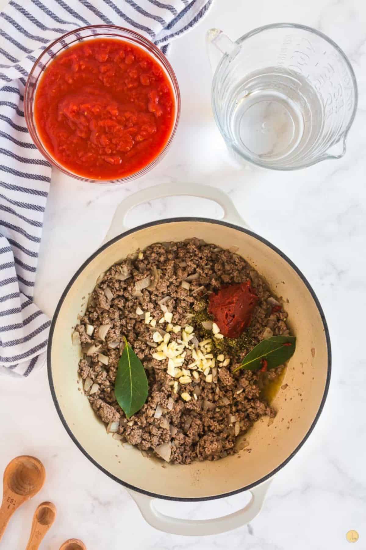 ground beef with spices and tomato paste in a pot