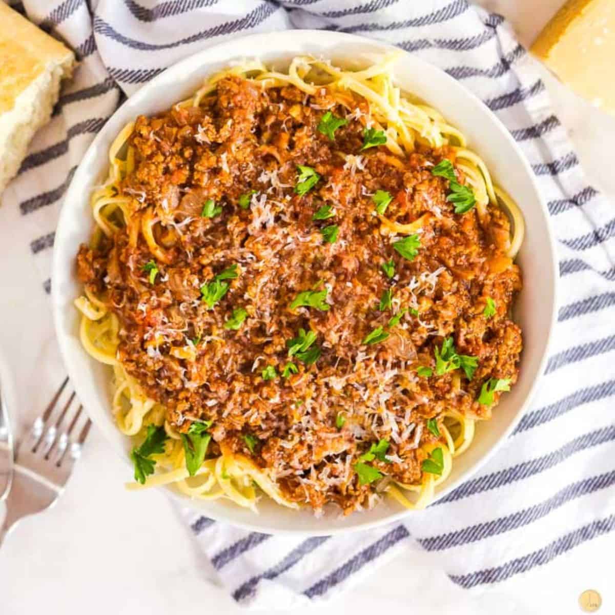 plate of spaghetti and meat sauce with a fork