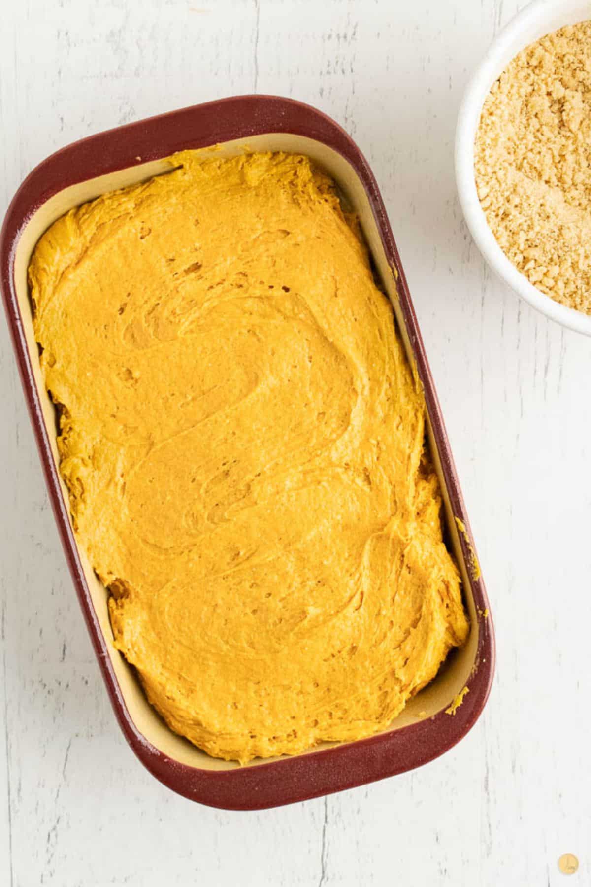 unbaked pumpkin bread in a loaf pan