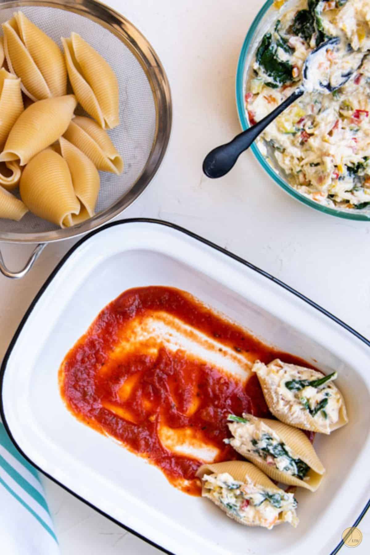 stuffed shell in a pan with sauce