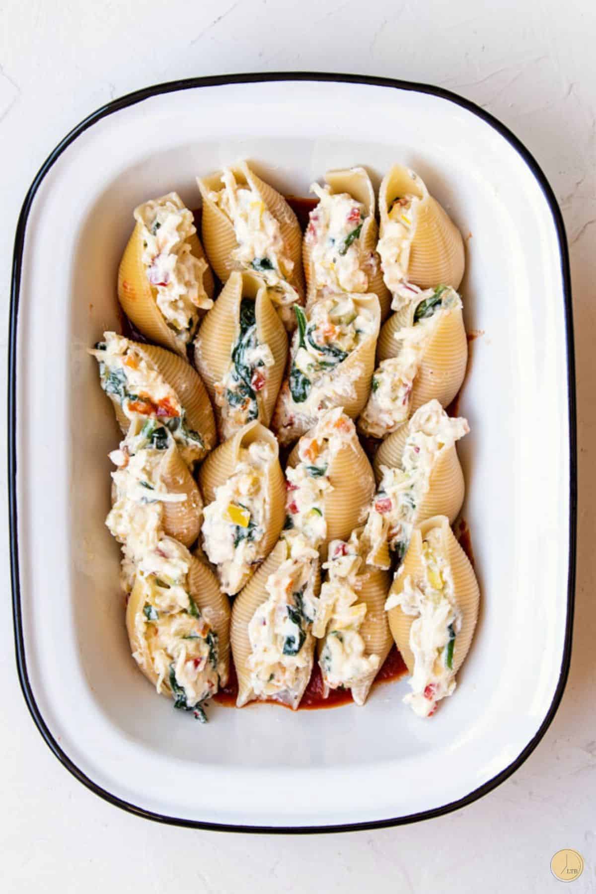 stuffed shells in a white dish