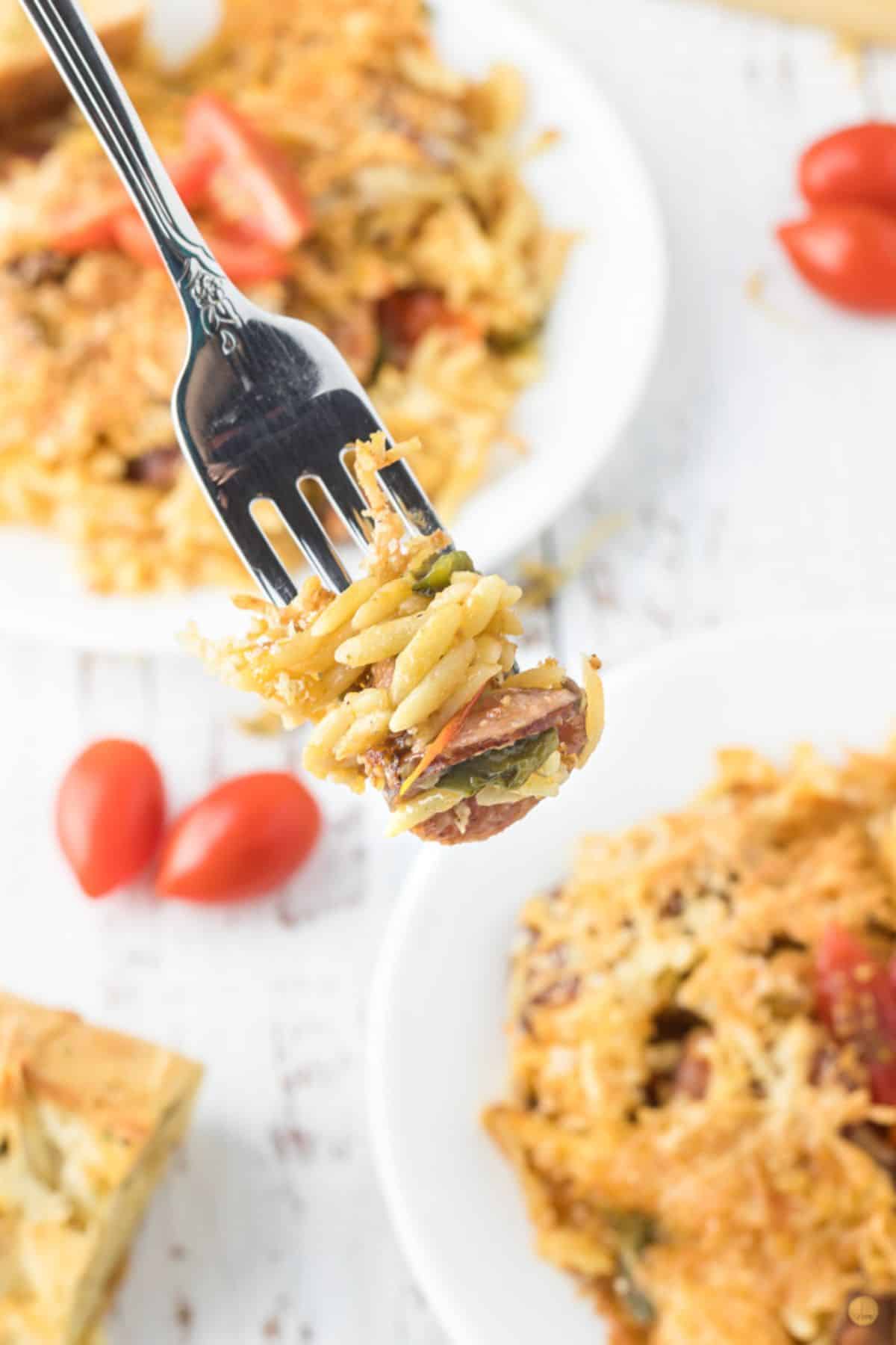 fork with bite of pasta and sausage